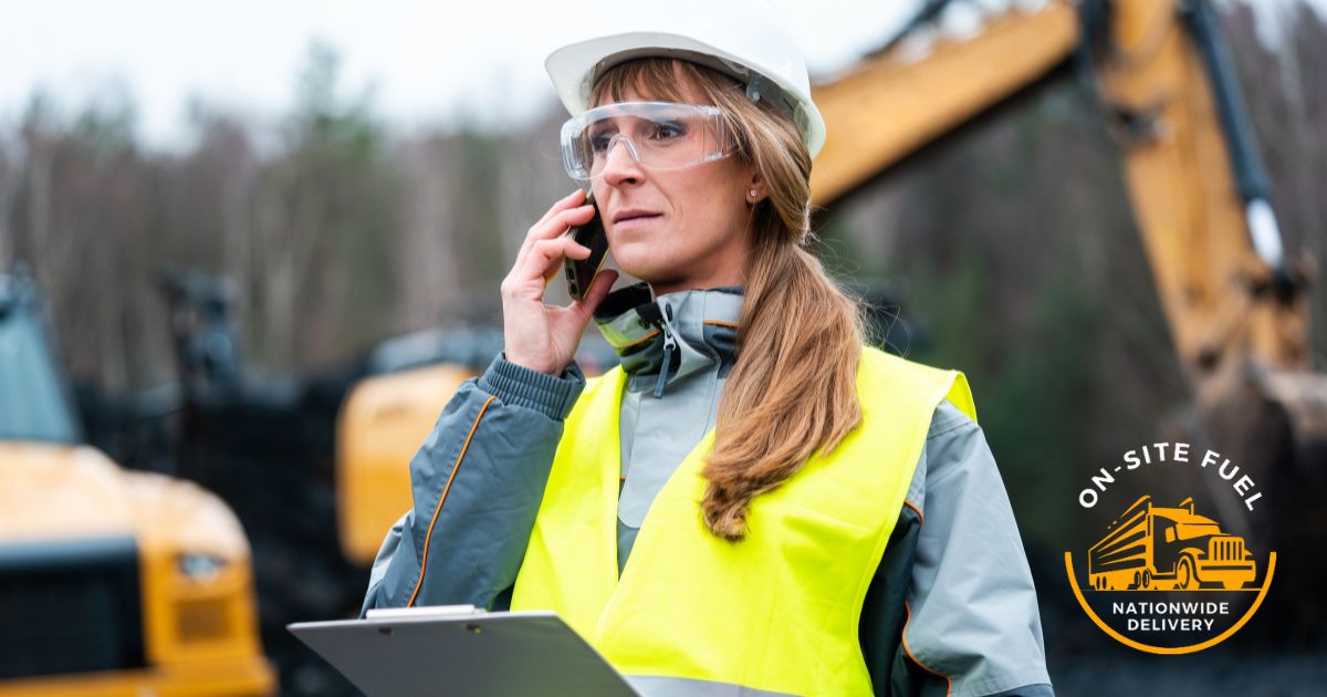 Woman construction supervisor making a cellular phone call asking obout diesel prices and ordering a delivery to job site.